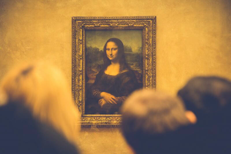 Huge crowds admiring the Mona Lisa a famous painting by Leonardo da Vinci