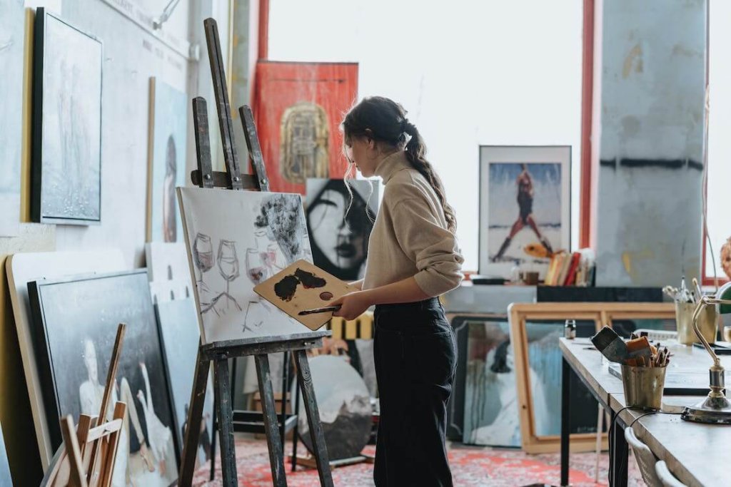artist working on a painting in her studio