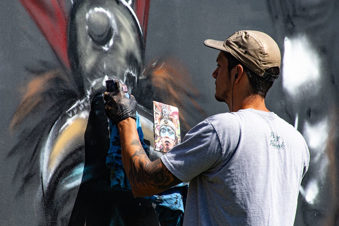 street artists painting a mural